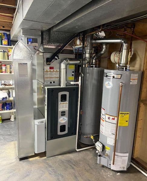 High-efficiency furnace and water heater installed in a basement setting.
