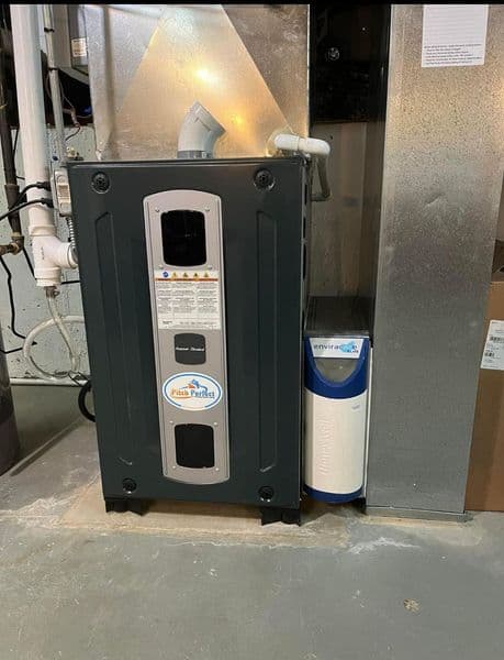 Home heating system with a modern furnace and water heater in a basement setting.